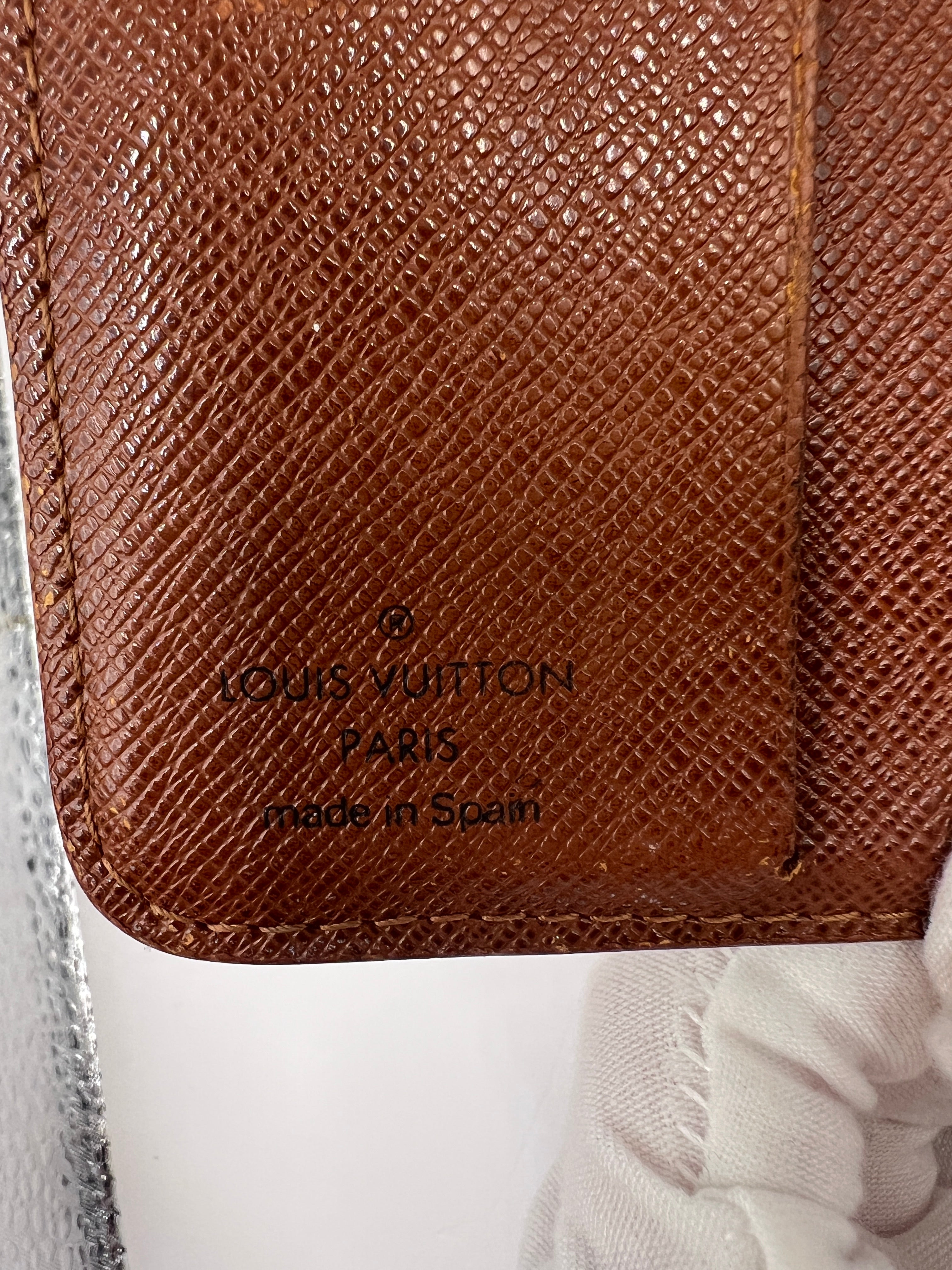 Louis Vuitton monogram compact wallet with snap closure